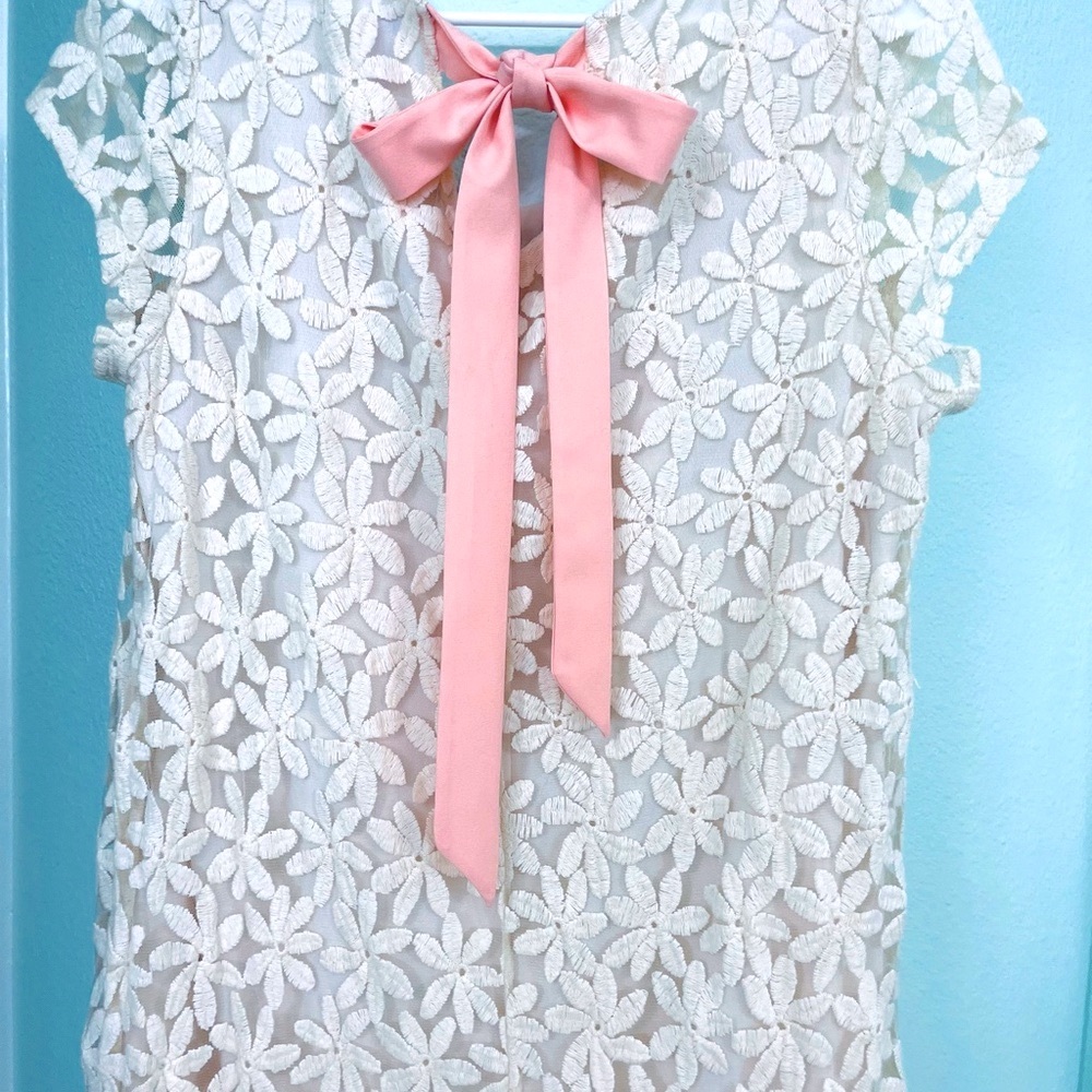 Beautiful Cream/white lacy dress with pink tie on back.